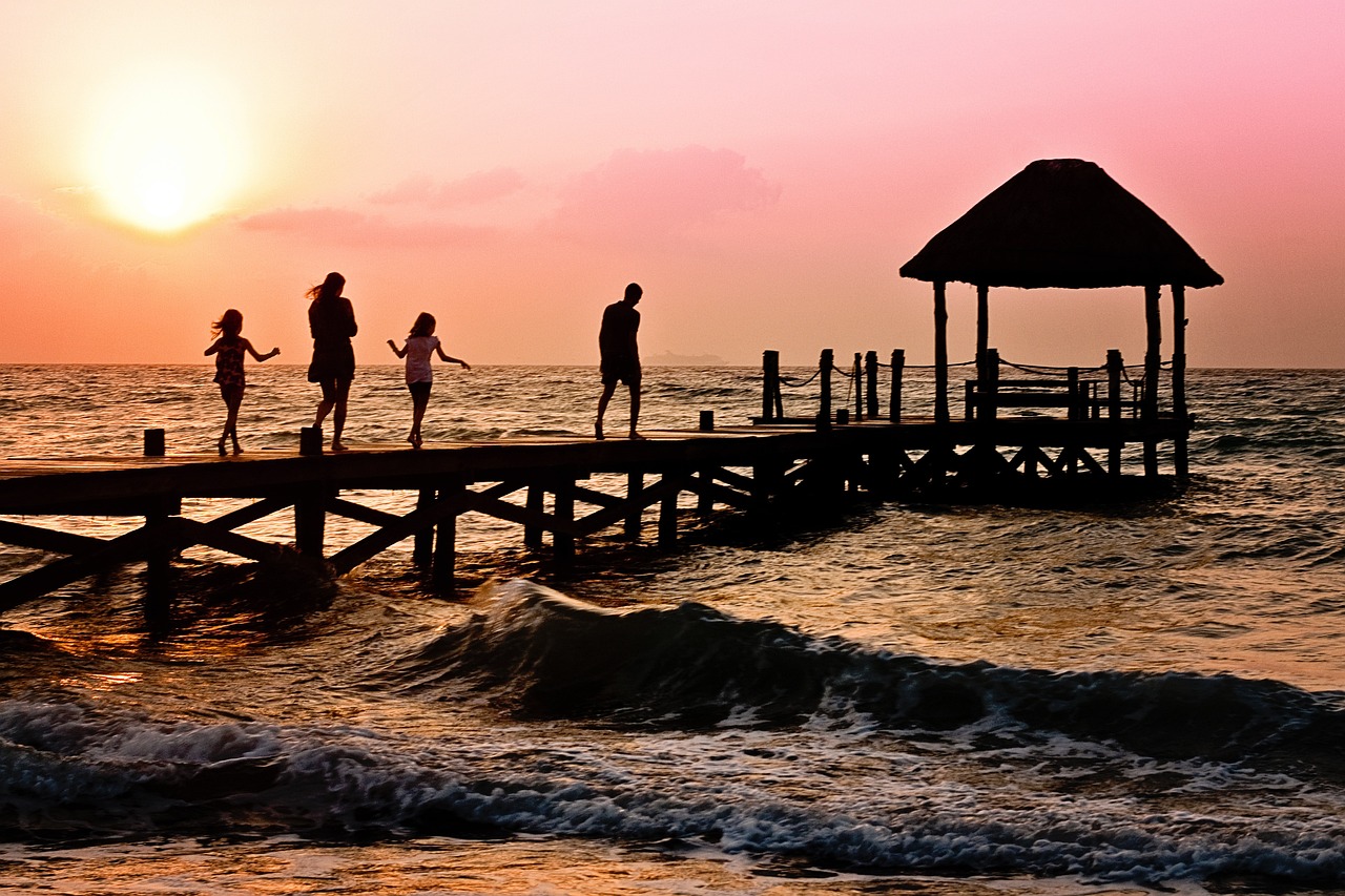 Family walking together on pier at cocoa beach