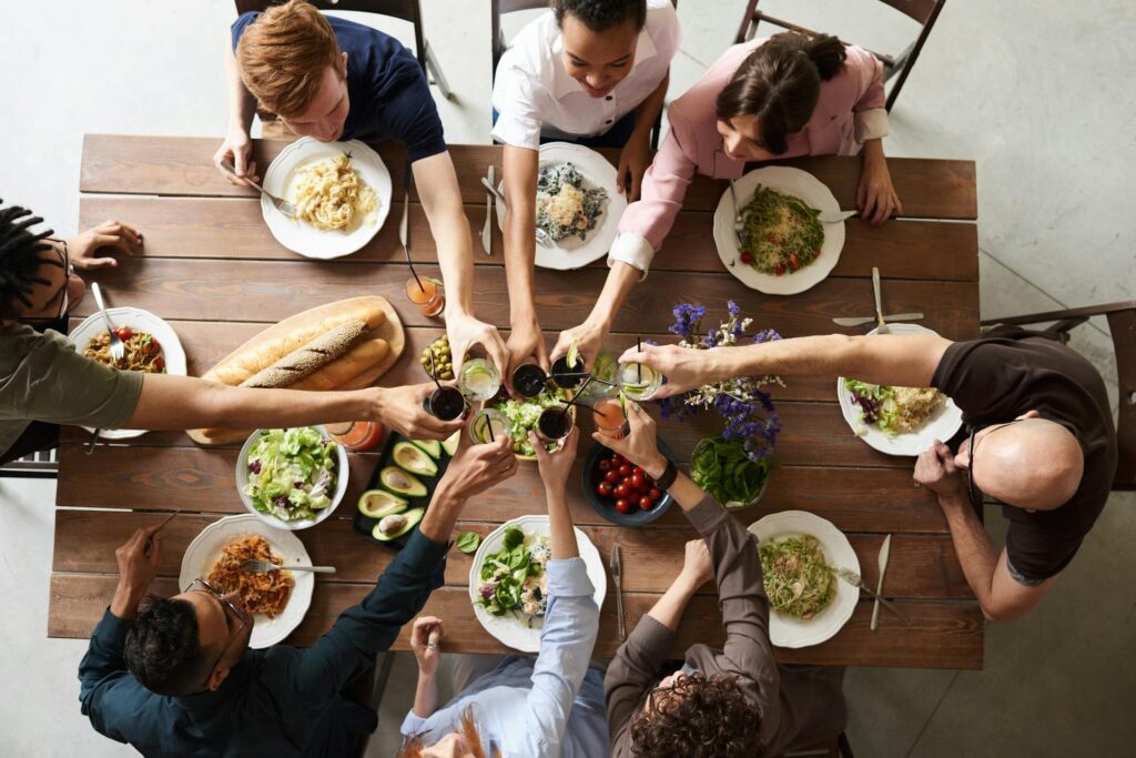 People eating food and drinking wine