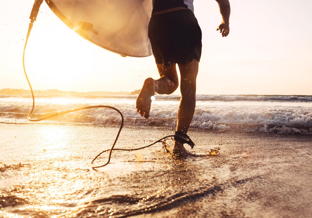 A surfer holding a surfboard